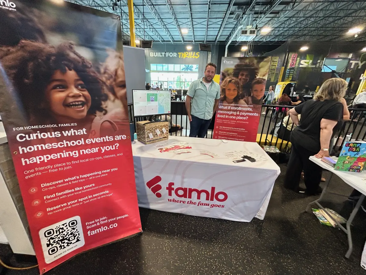 The Famlo table at an expo, with two banners and a tablecloth