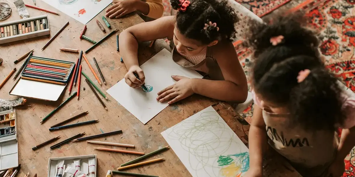 Children getting their homeschool hours while coloring with pencils