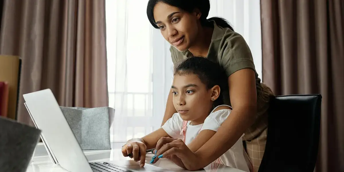 A mother helps her daughter with homeschooling mid-year